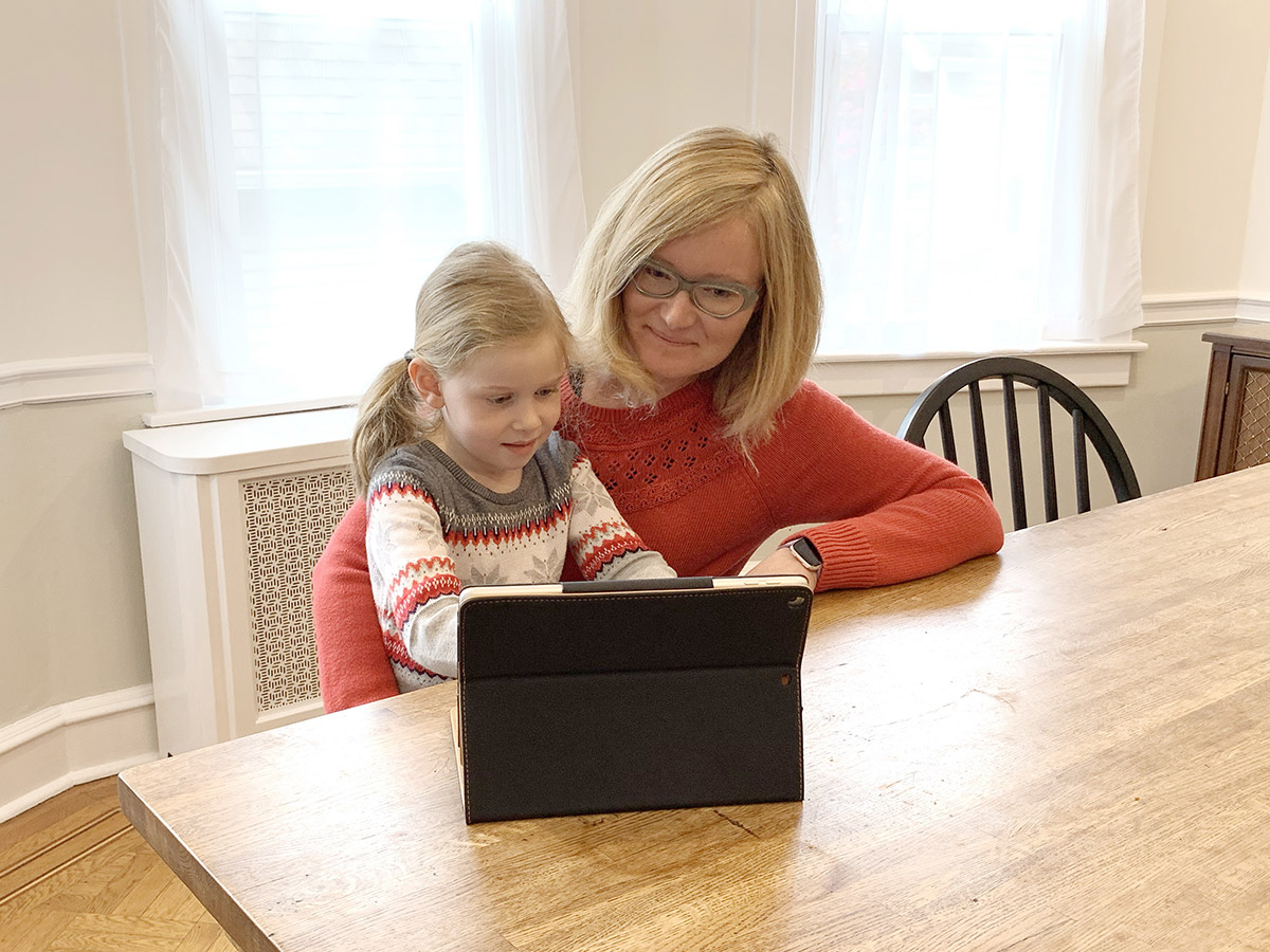Mother and daughter looking at tablet together