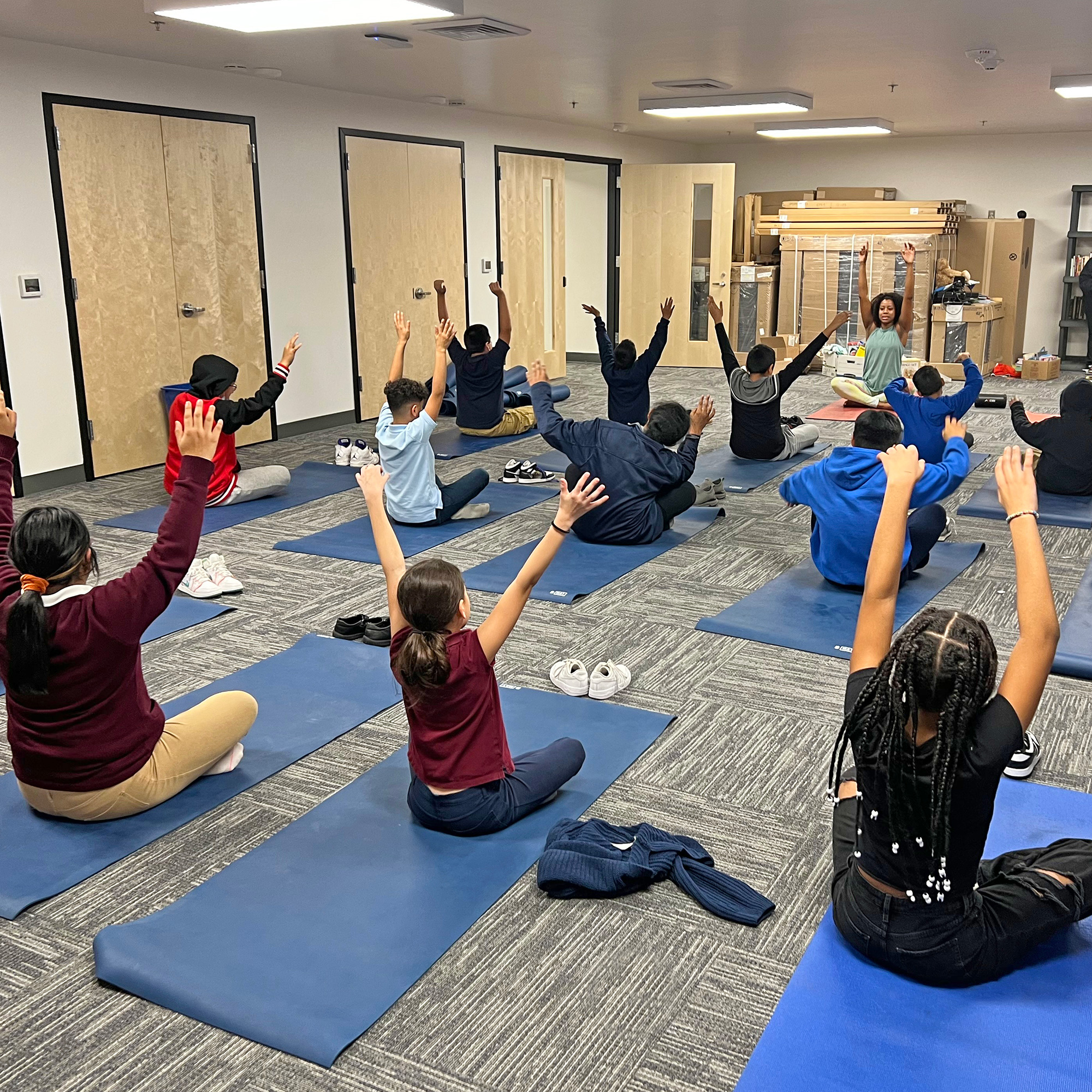 Schoolchildren practicing yoga in a classroom