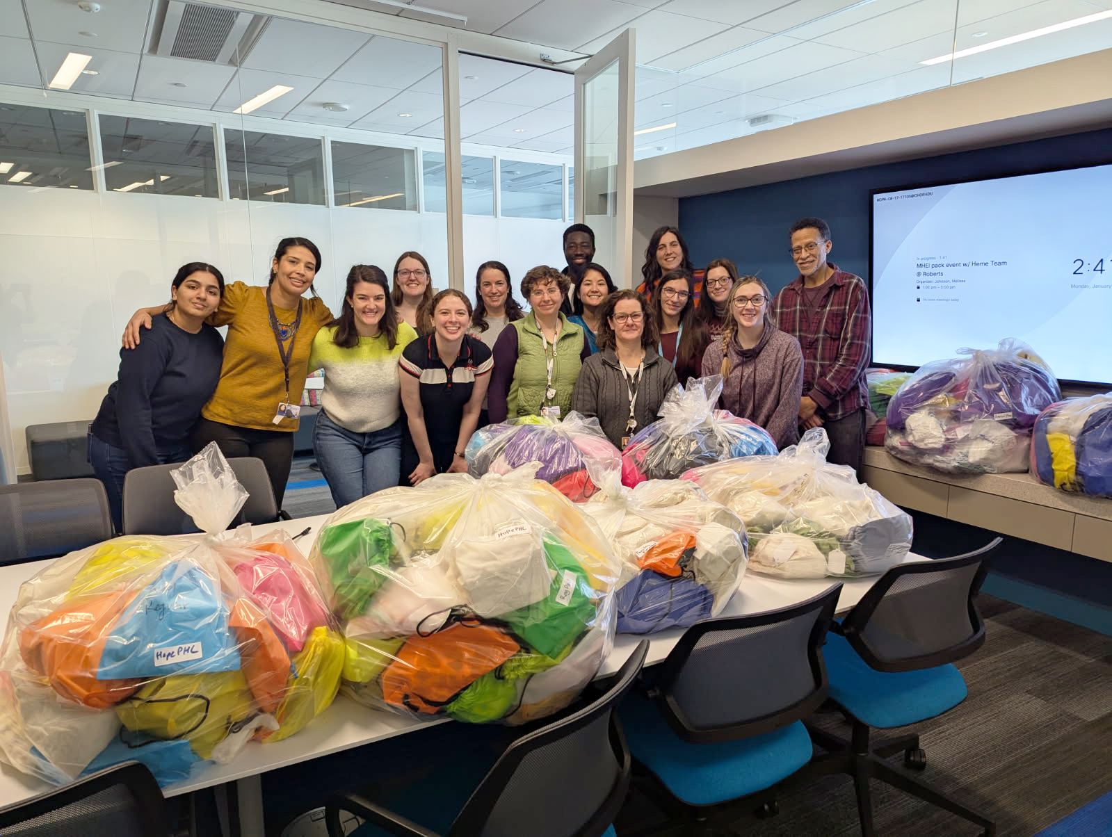 Volunteers posing with assembled 'period packs'